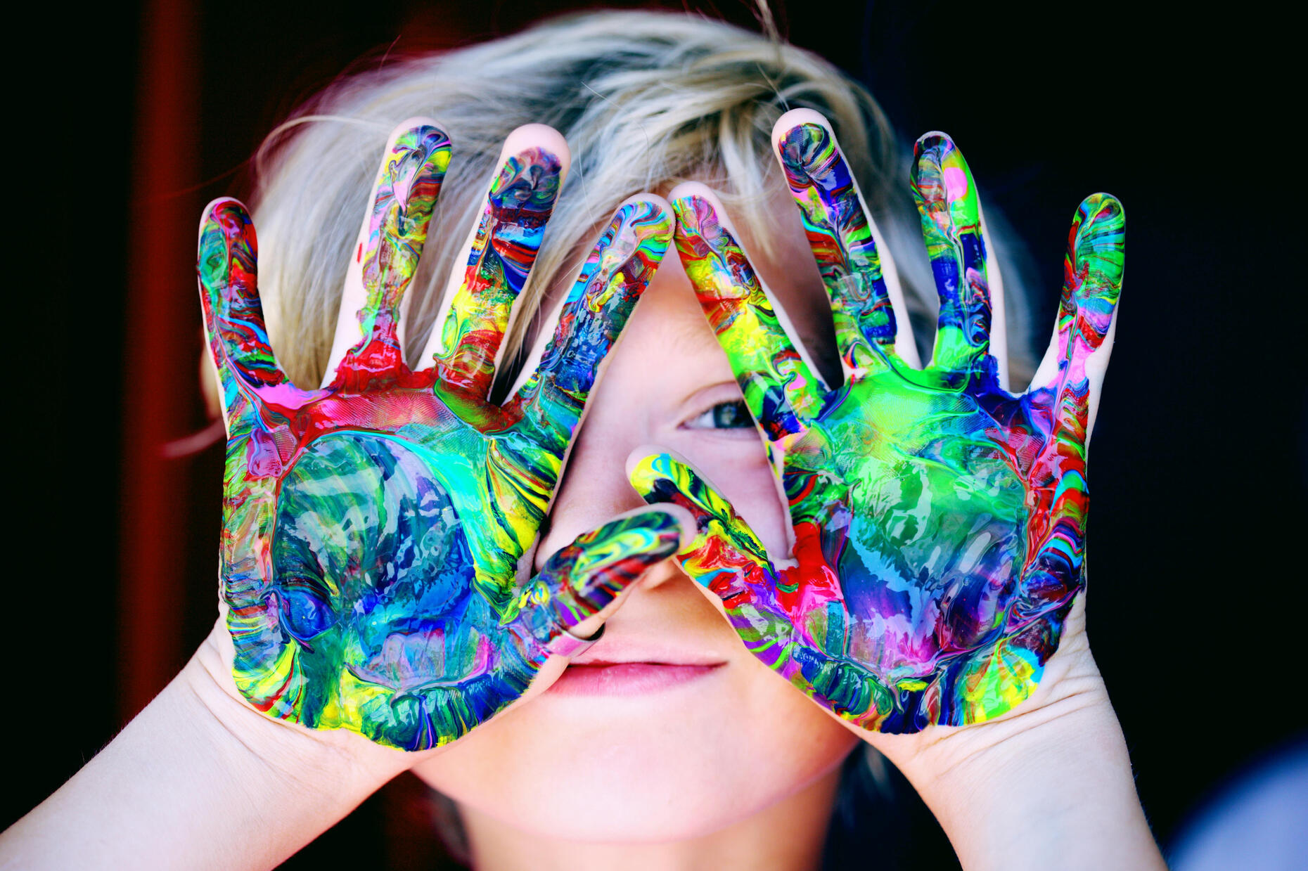Child with paint on their hands. Photo by Alexander Grey via Pexels.